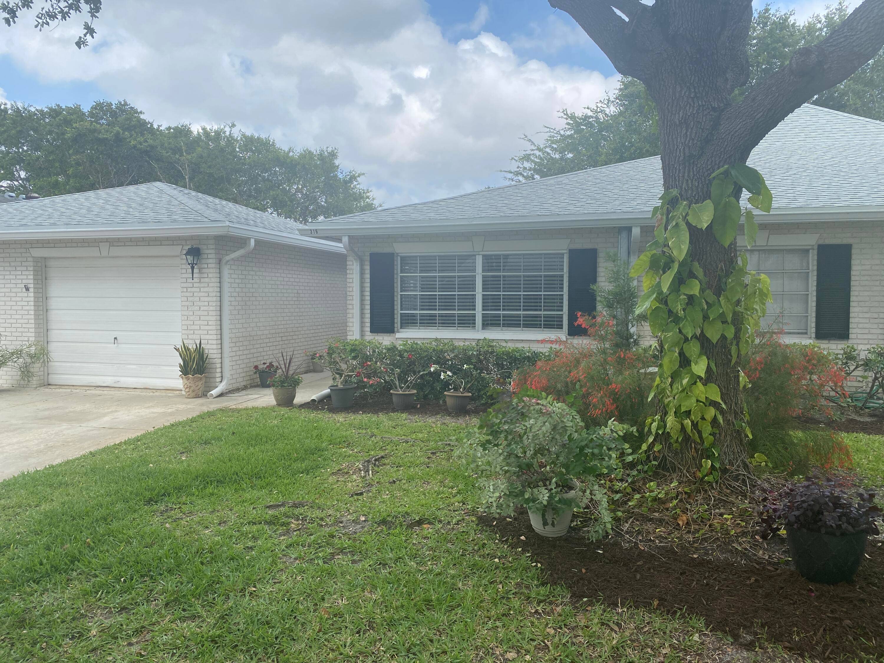 Wonderfully updated and spacious 1 bedroom, 1 1 2 bath villa w large garage and driveway, huge private screened patio, located on quiet end of the street.