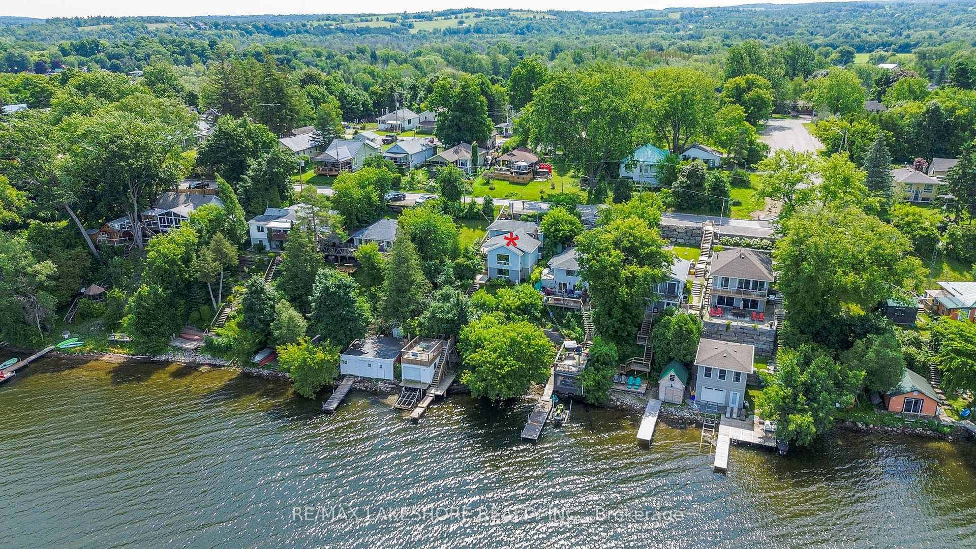 This charming waterfront home has been well kept and features an expansive, bright living room with a picture window offering wonderful views and a propane fireplace, an easy to work ...