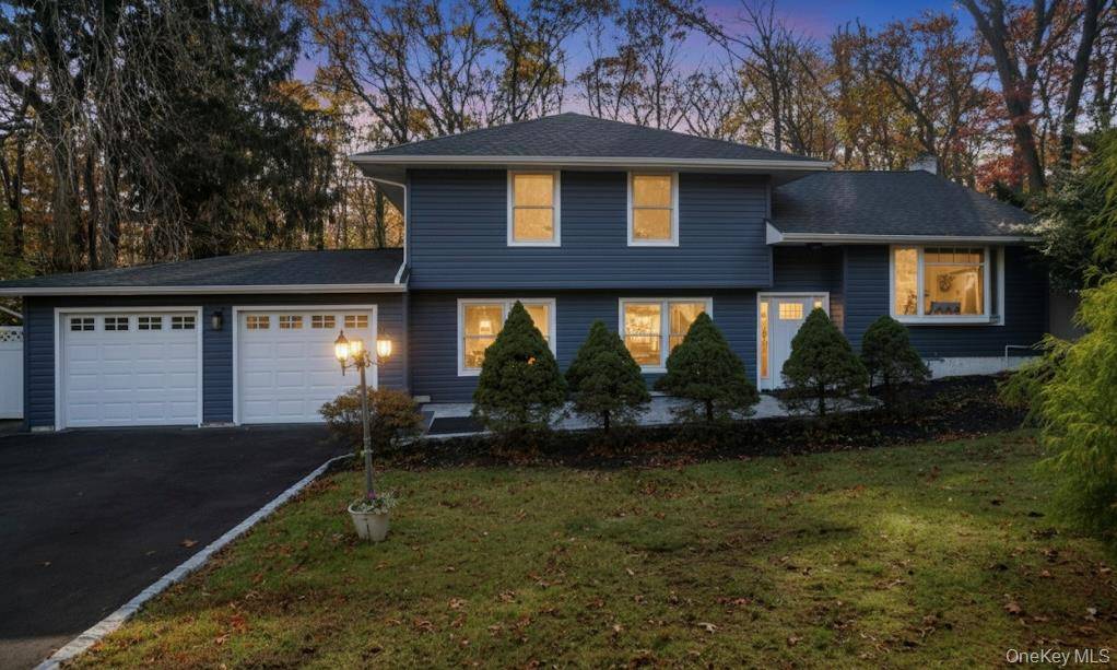 This beautifully updated home features a new roof, central air conditioning, siding, gutters, doors, and garage door, along with a brand new deck, paver patio, and driveway.