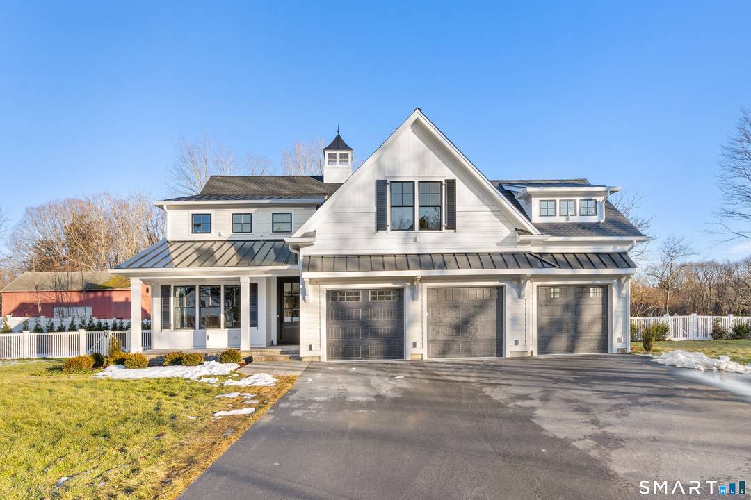 Less than one mile from downtown Madison, this new construction home offers refined living with white oak floors, custom millwork, coffered ceilings, and abundant natural light throughout.