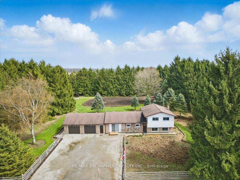 Welcome to 874 Robinson Road, a beautifully maintained side split nestled on a fully fenced 1.