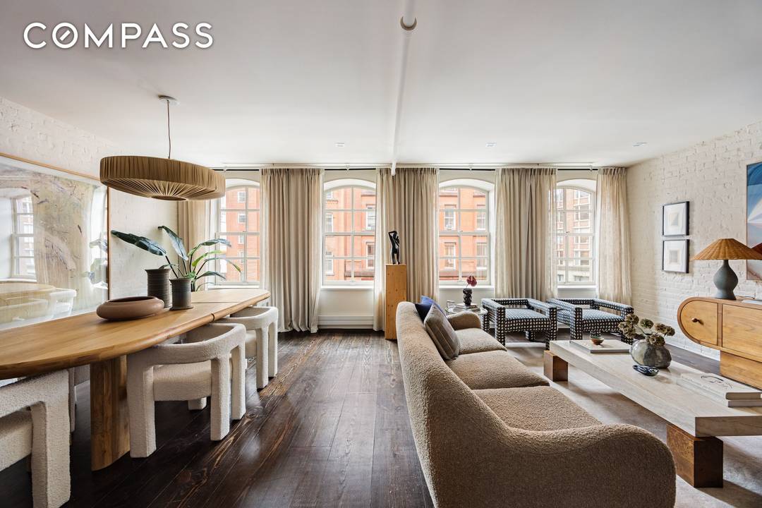 Modern luxury meets classic New York architecture in this exceptional floor through Tribeca loft, set on a coveted landmarked stretch of Duane Street.