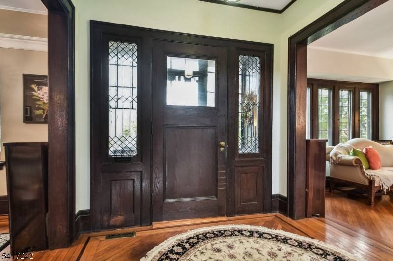 Welcome to this spacious, sun filled, and distinctive home, ideally located in a coveted neighborhood just a short stroll to town and the NYC train.