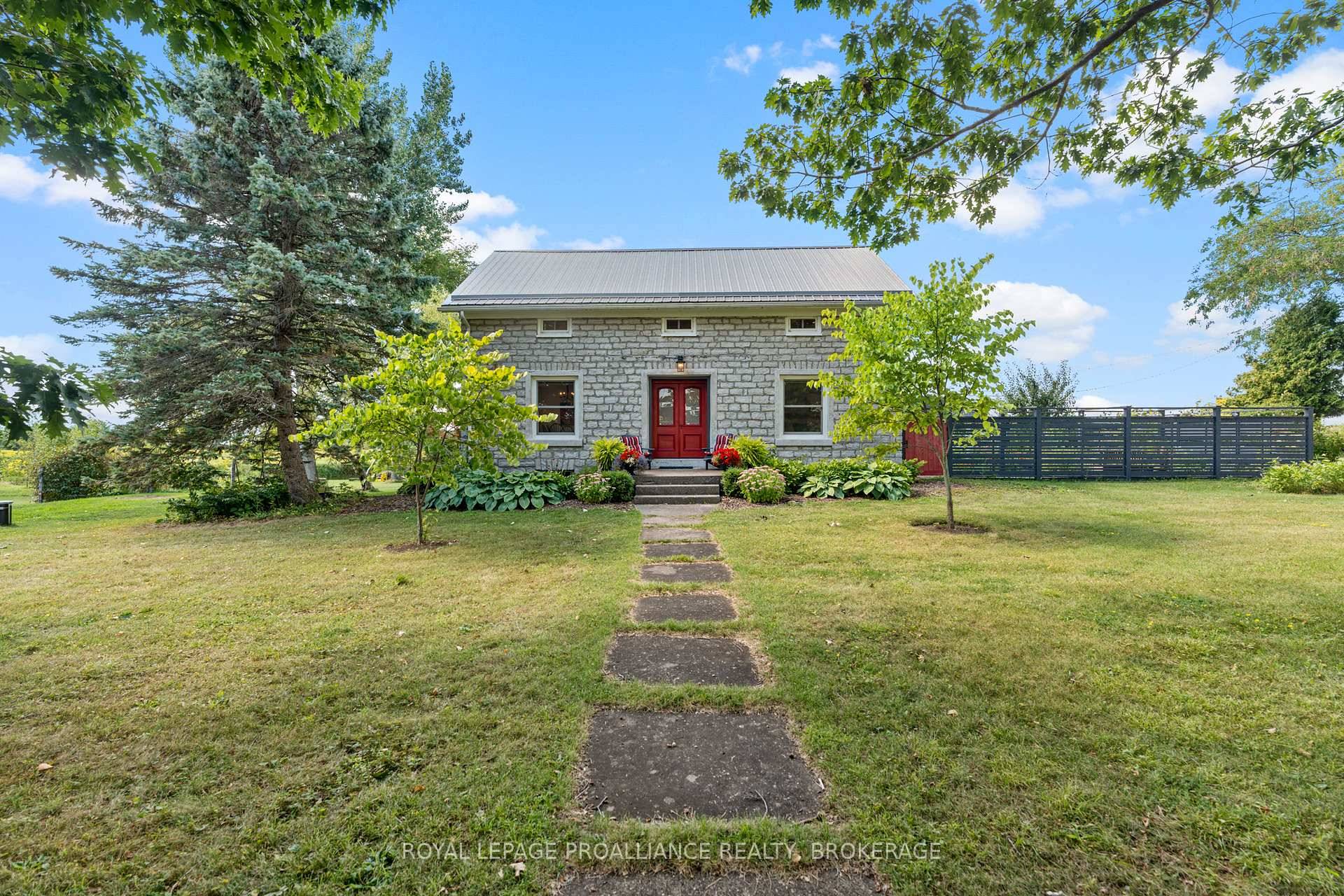 Outstanding 19th Century limestone situated on 32 picturesque acres on Wolfe Island, within a 15 minute ferry ride to downtown Kingston !