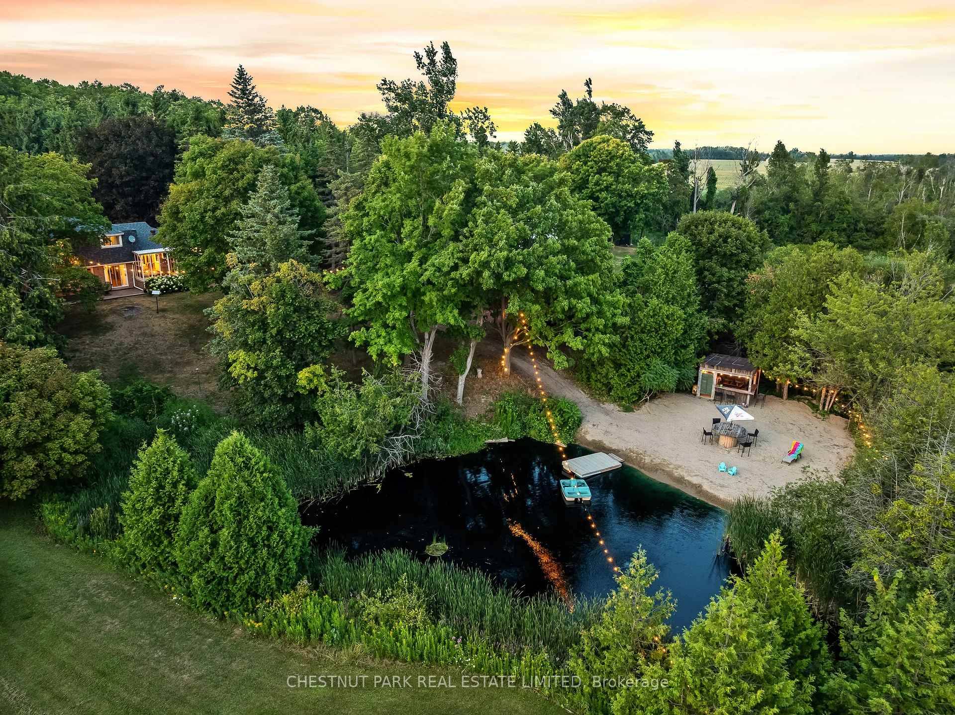 Spectacular 1 acre property with picturesque pond views, private beach, and your own tiki bar, with hydro !