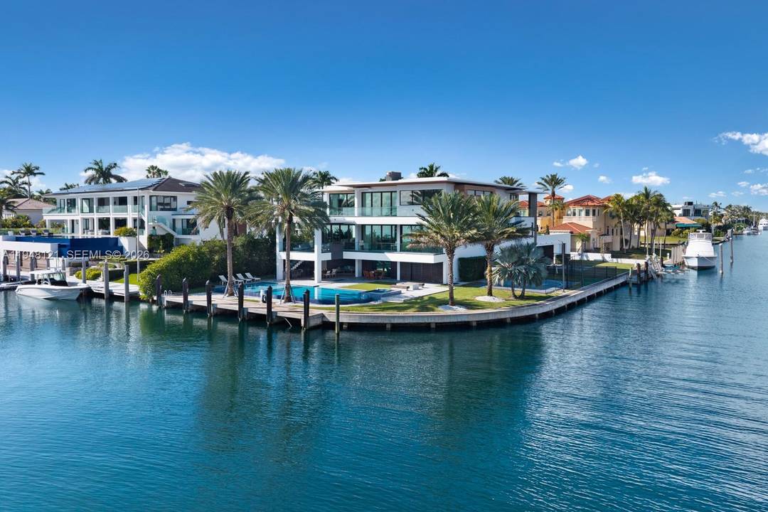 Spectacular bayfront modern family home on a rare corner point lot with 300 feet of prime waterfront in an unbeatable location.