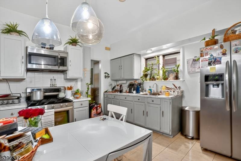 Exceptional Two Family Home with Bonus Finished Attic Ideal for Investment or Extended Living !