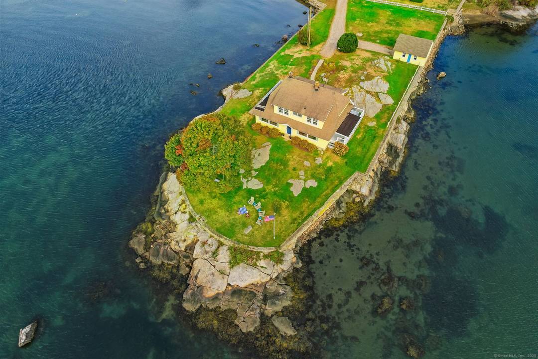 RARE OPPORTUNITY ! Perched proudly on its own peninsula and surrounded by water, this 1920 Dutch Colonial Revival home offers a unique blend of timeless architecture, historic charm, and breathtaking ...