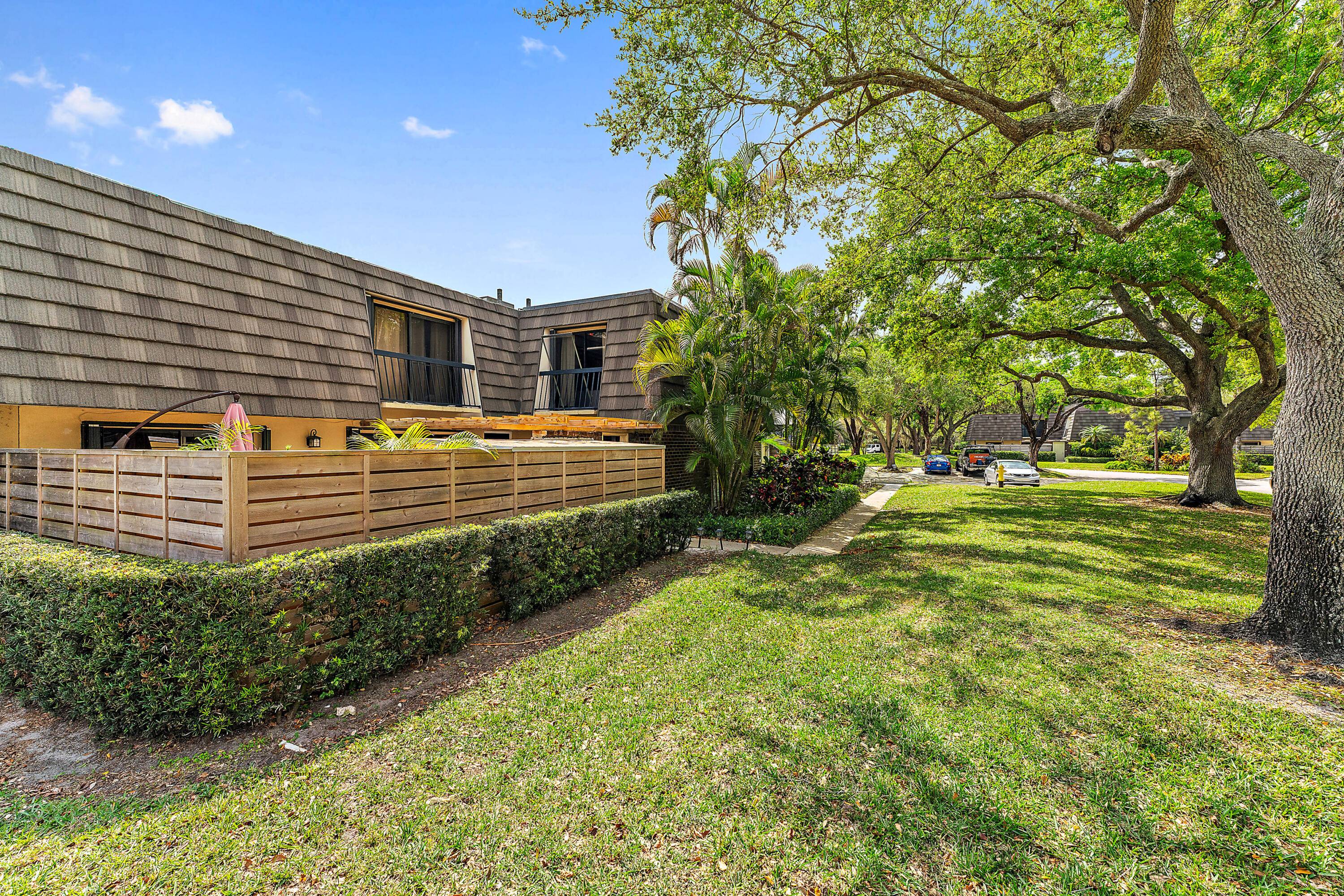This charming home in the highly desirable PGA National community sits on an expansive corner lot with tons of lush green space just steps from the community pool and pickleball ...
