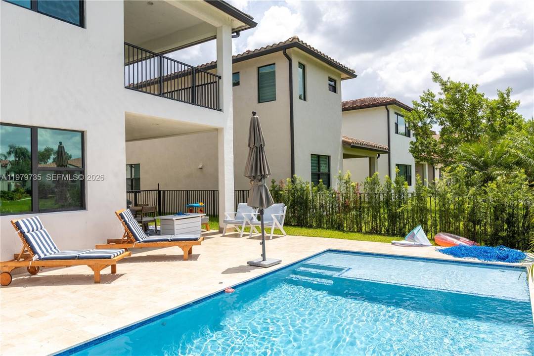 Exquisite residence located in the prestigious gated community of Raintree in Pembroke Pines.