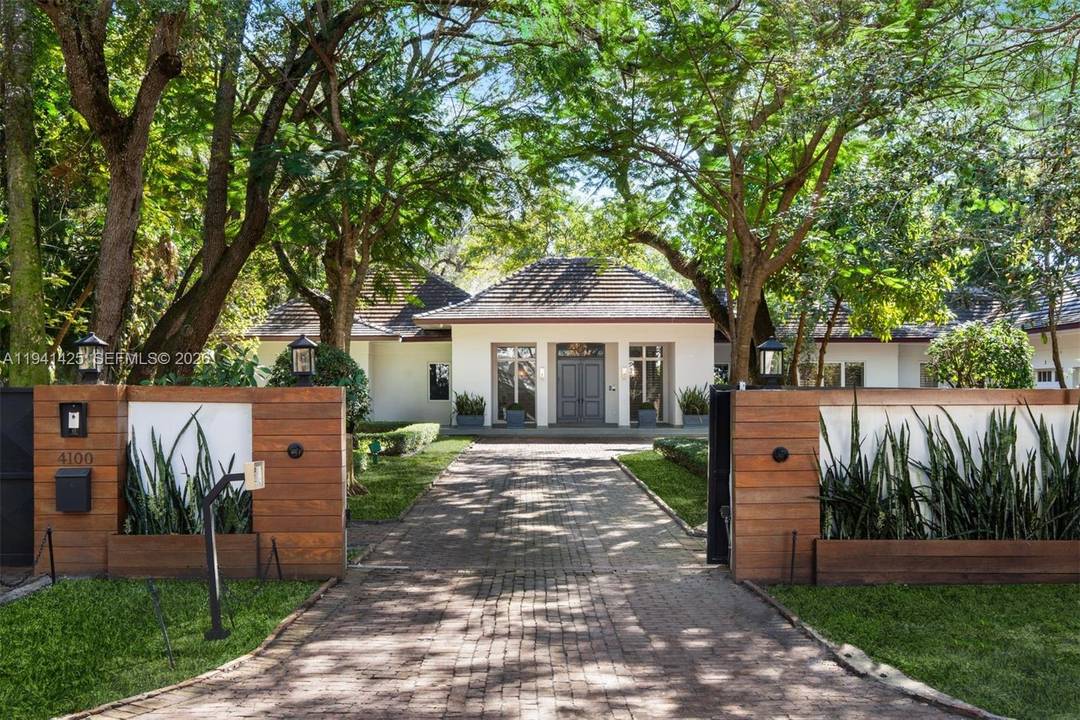 Set behind lush landscaping on approximately 1.