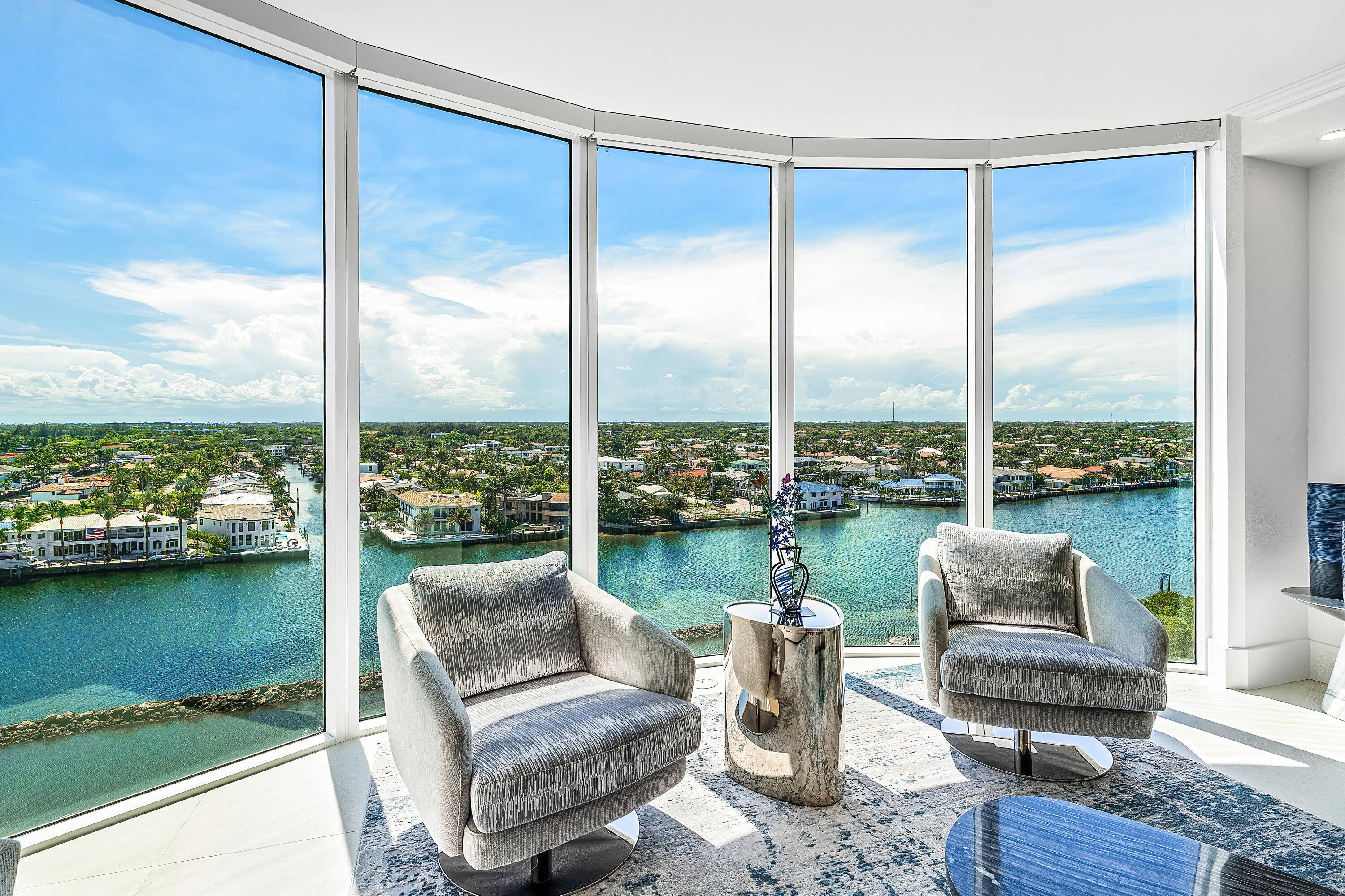 Perched high above a uniquely beautiful stretch of the Intracoastal, this rarely available corner residence captures sweeping views of the water, lush preserve, sparkling city lights, and distant ocean.