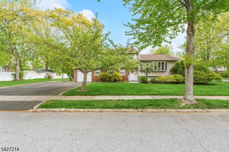Welcome to this sun drenched, beautifully maintained sugar maple split level home, perfectly situated on one of the most picturesque streets in town.