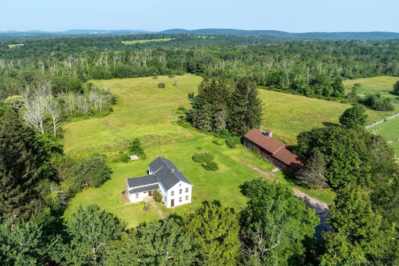 Historic 1830s Goshen Farmhouse Barn on 26 Acres Subdivision Potential This 1830s farmhouse sanctuary, spread across 26 pristine acres in sought after Goshen, presents a rare opportunity with subdivision potential.