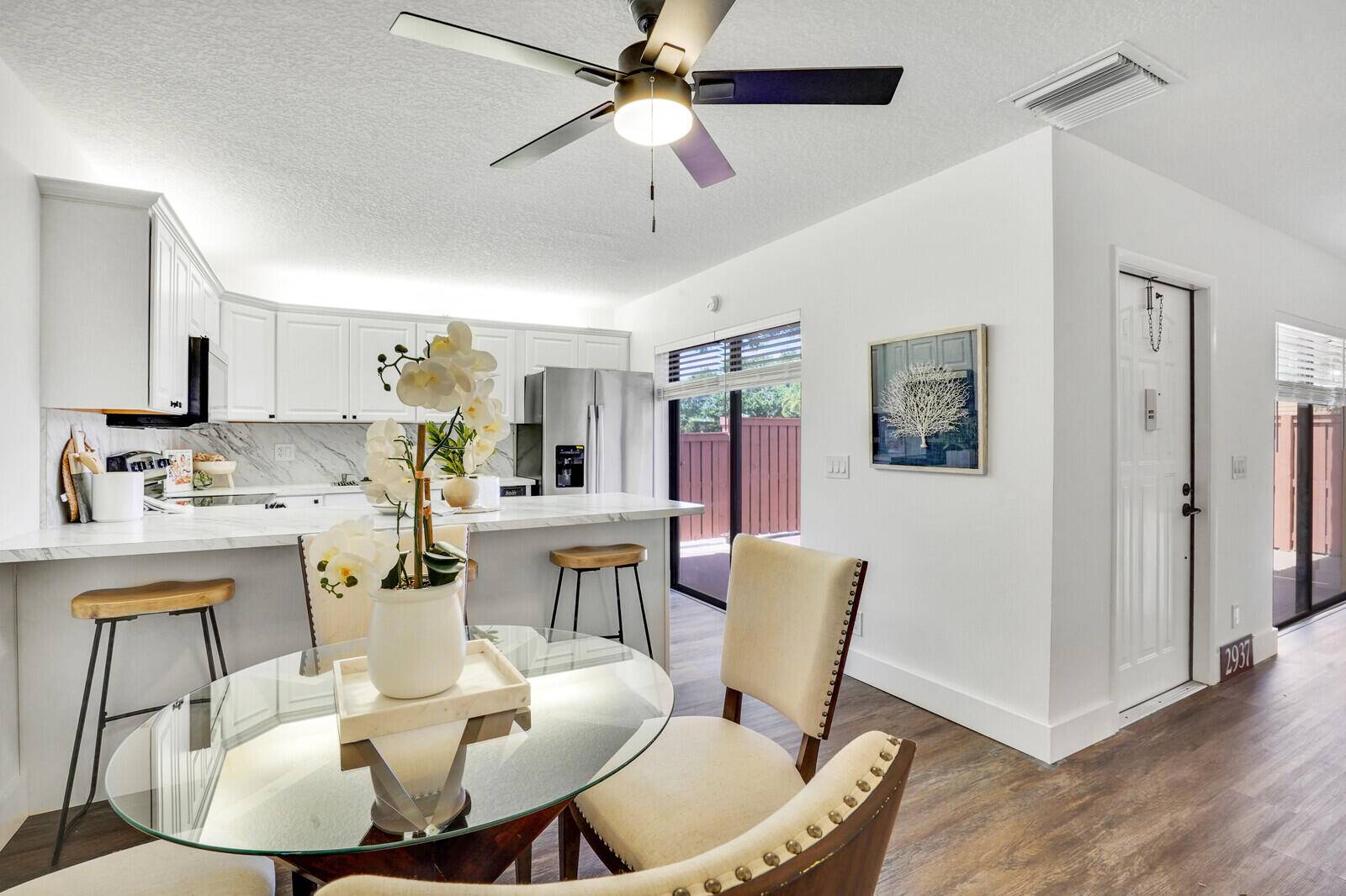 Live the lifestyle you've imagined in this fully updated, north facing corner townhome just minutes from the sand surf of world famous Deerfield Beach.