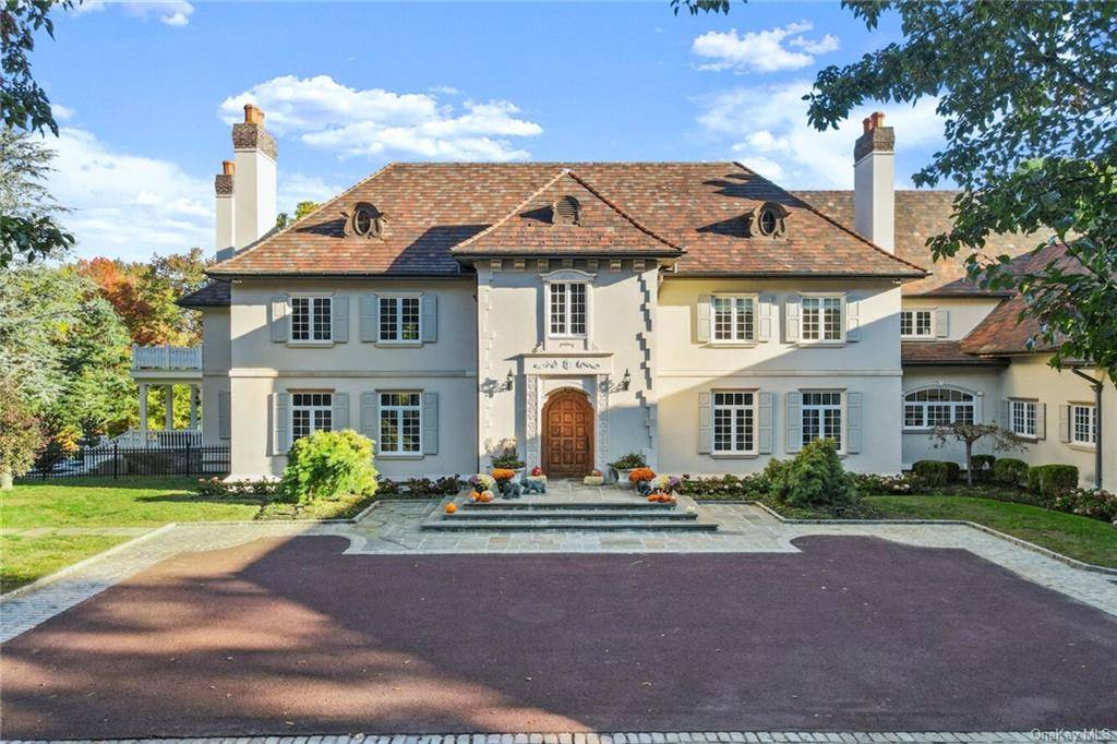 Cosseted within the gates of the exclusive Greenwich, Connecticut Conyers Farm Association with 24hr security, this baronial French Normandy chateau is poised on more than thirteen park like acres.