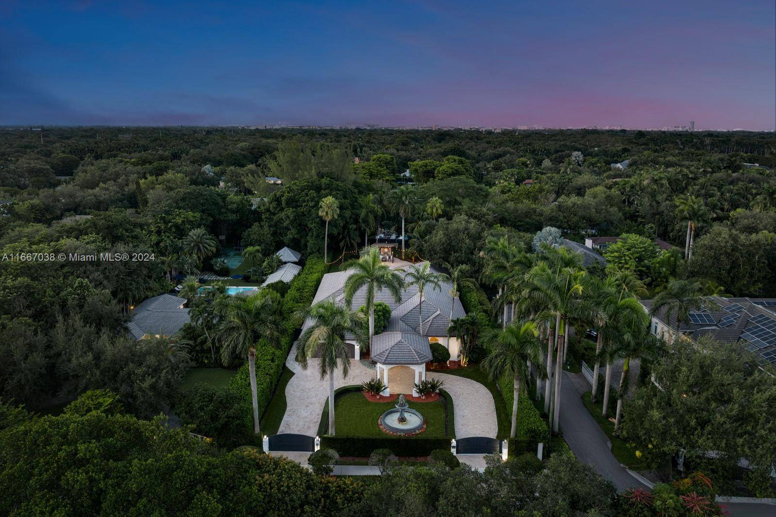 Nestled in North Pinecrest, this privately gated estate epitomizes timeless luxury, spanning over a 30000 sqft lot.
