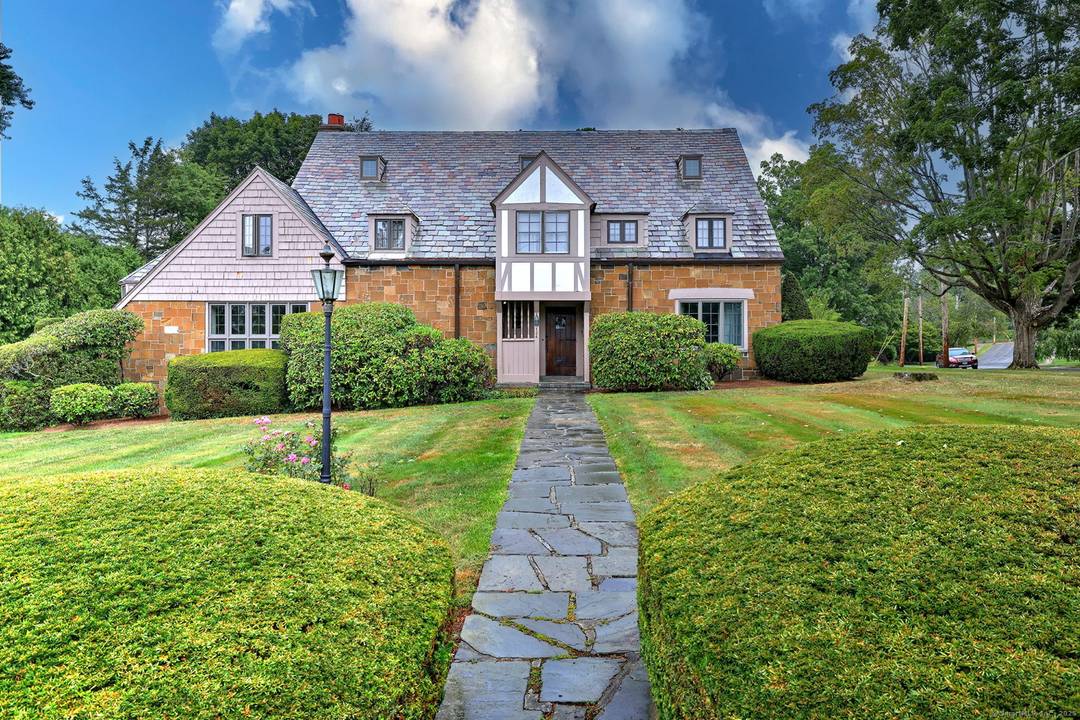 Elegant 1928 Tudor inspired Colonial in the heart of Spring Glen, gracefully set on a professionally landscaped 1 2 acre corner lot with undeniable curb appeal.