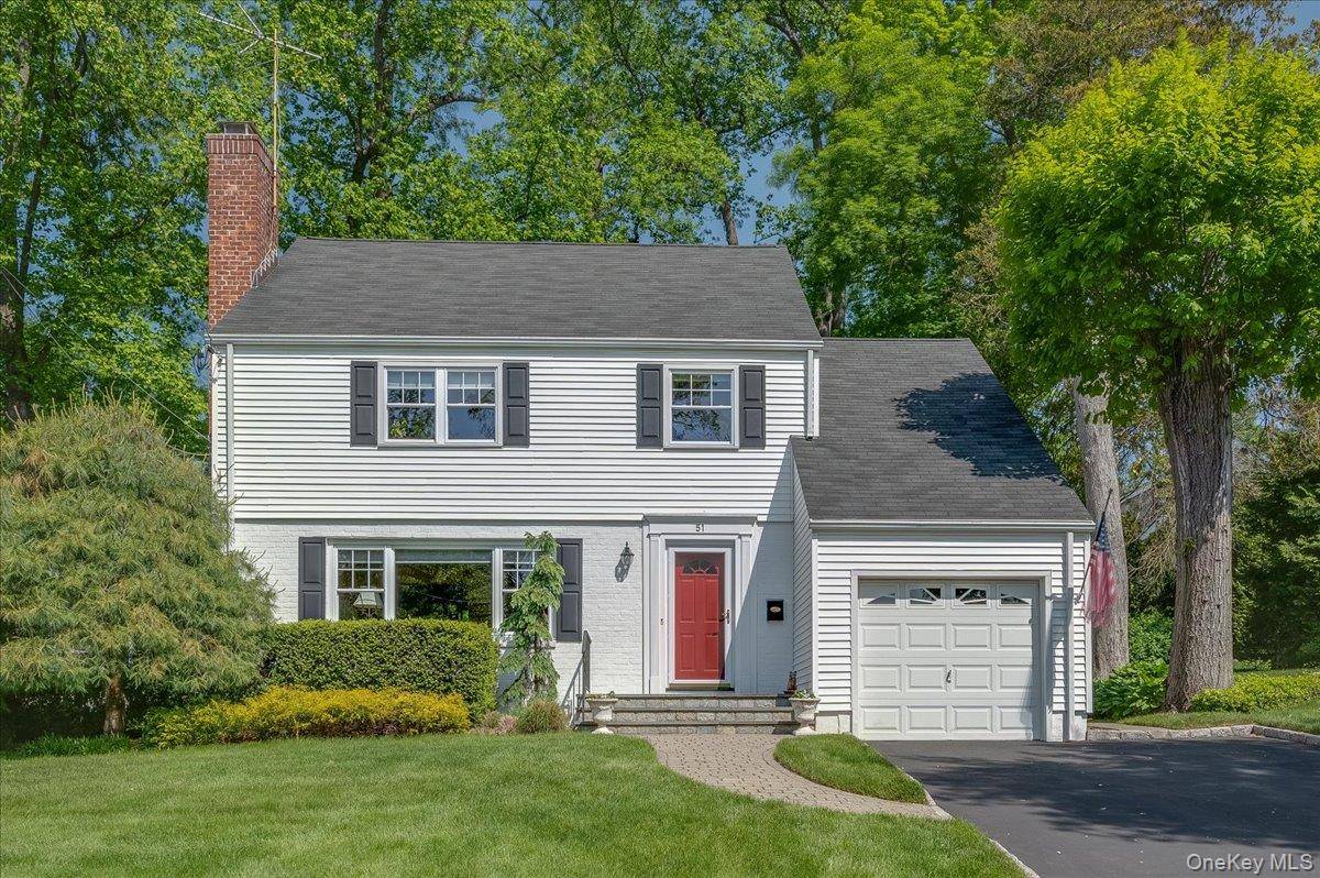 Pride of ownership shines in this Wilmot Woods side hall Colonial.