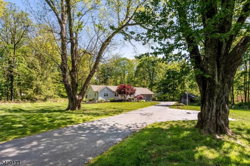 Perfectly set back from the road on a private, serene, flat lot on a cul de sac street, this lovely Cape style home offers peaceful surroundings while remaining just minutes ...