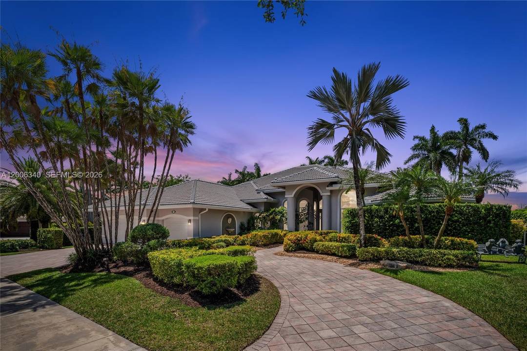 Stunning single story estate in the exclusive Weston Hills Country Club, set on an oversized 0.