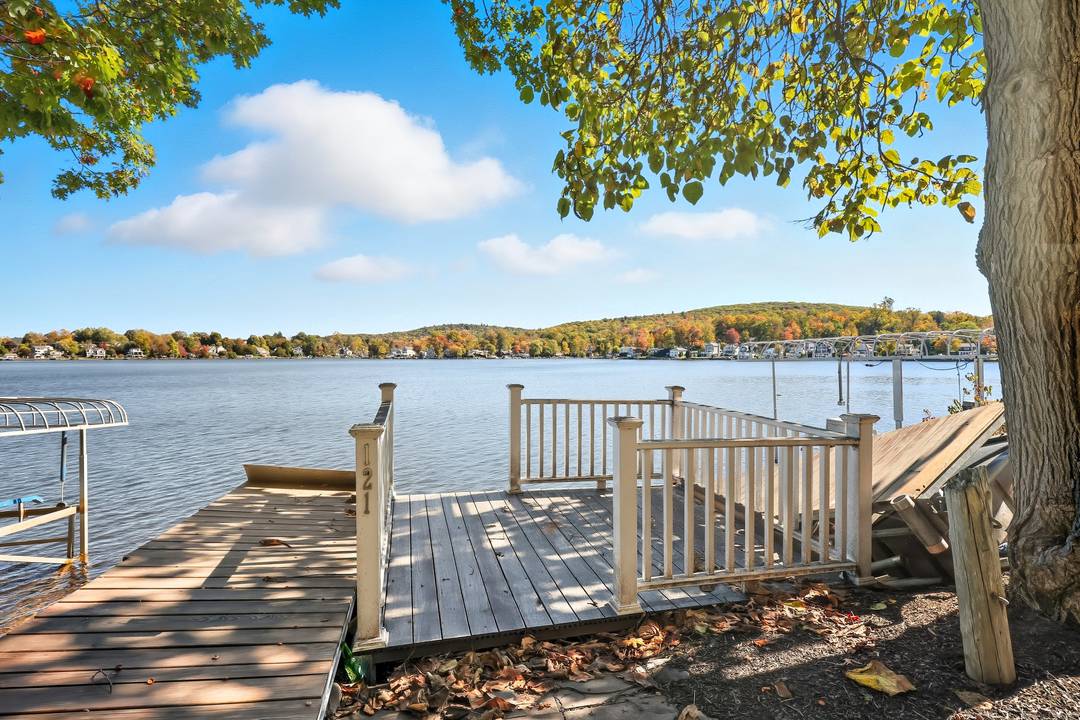 Discover lakeside living at its finest with this renovated 5 bedroom, 4 bath family estate set privately on a full acre overlooking picturesque Highland Lake.