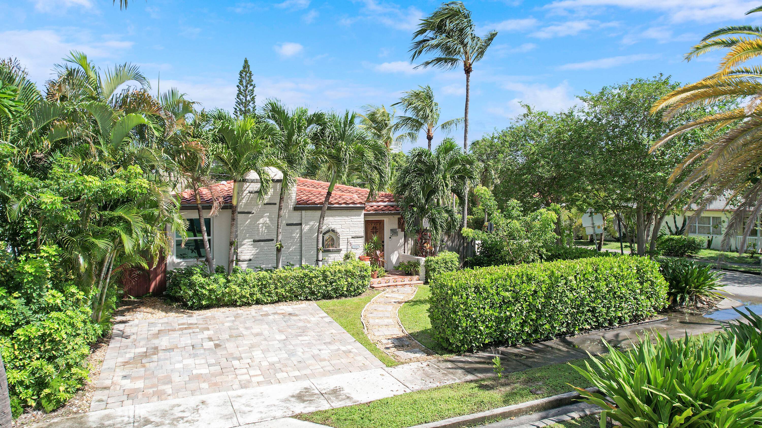 Welcome home to this lushly landscaped, Spanish style gem in the desirable, no HOA Northwood neighborhood.