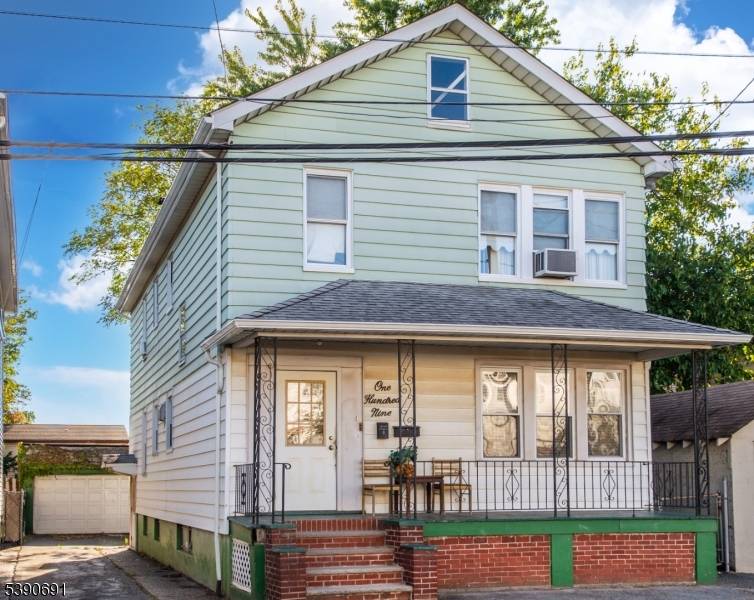 Two family home with 2 bedrooms on each floor, eat in kitchen, living room.