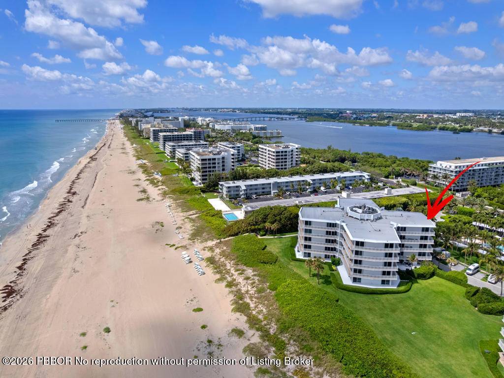 Impeccably renovated 3BR 3BA corner residence offers coastal living with sweeping ocean, Intracoastal, and pool views from a spacious wraparound terrace.