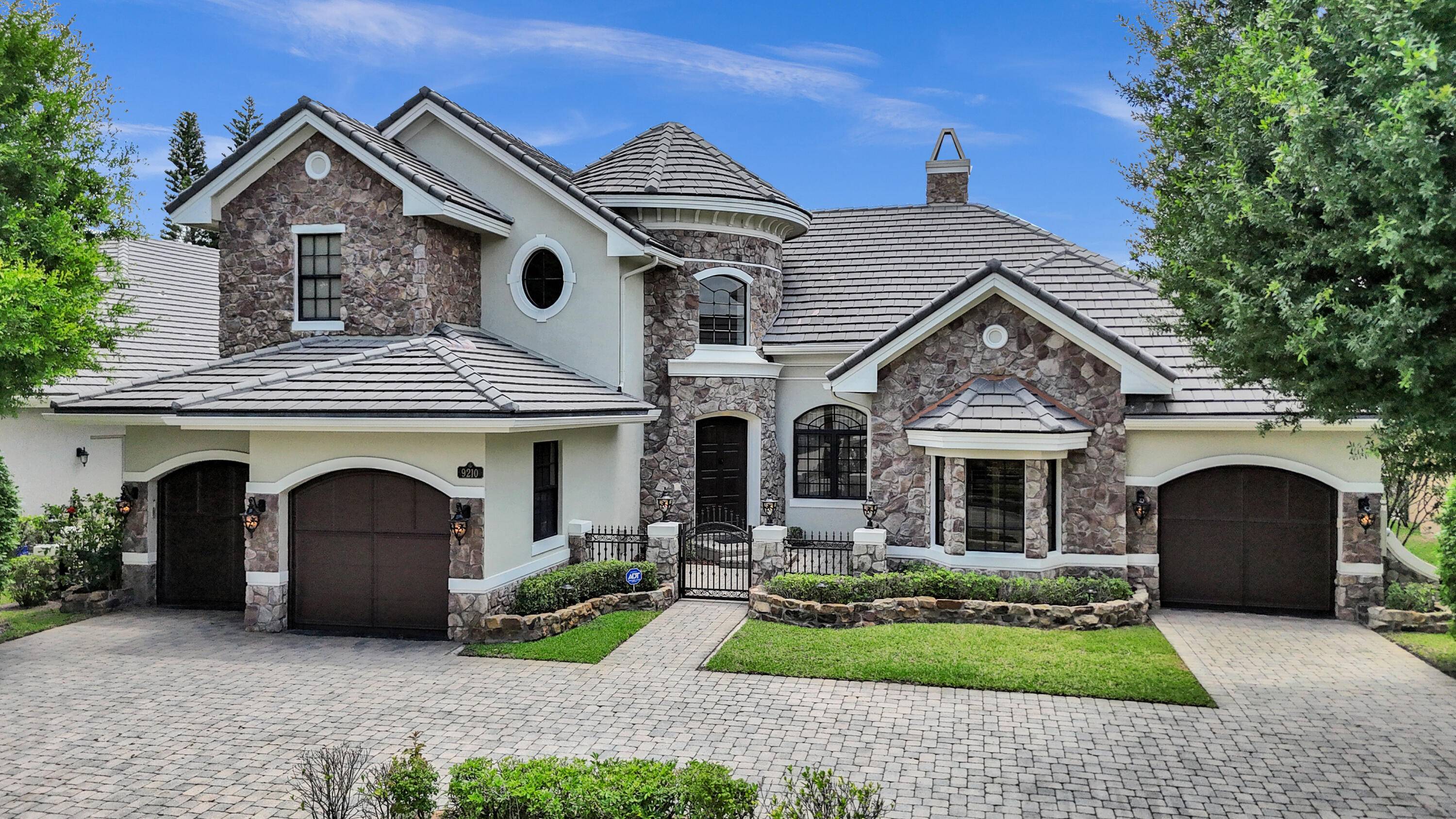 Nestled within the prestigious Equus community in Boynton Beach, this exceptional 4 bedroom, 5.