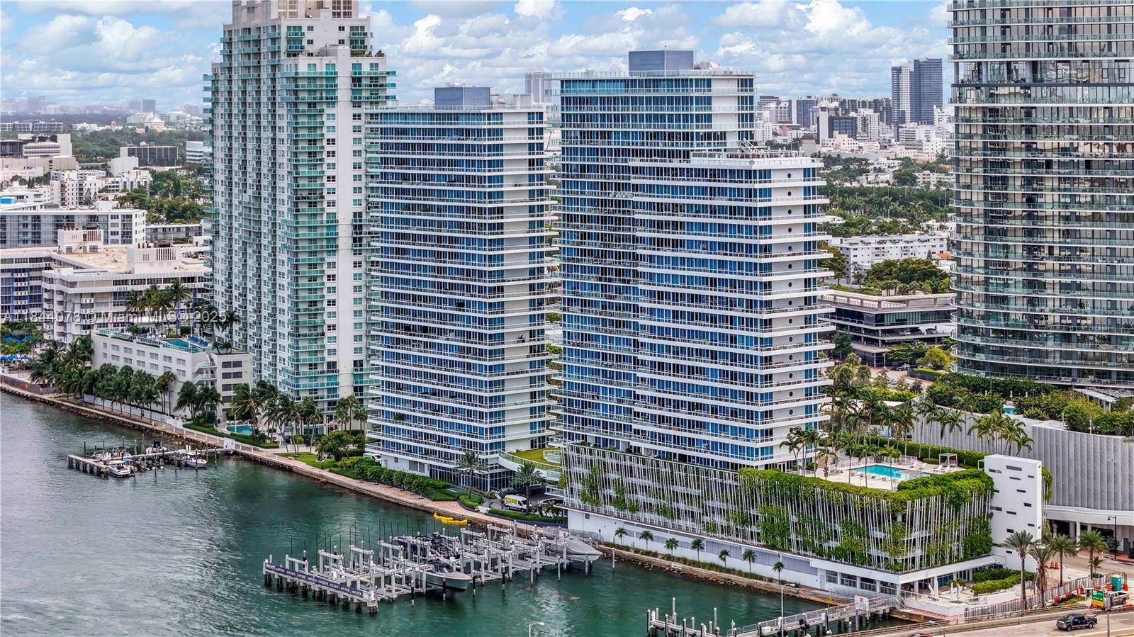 Spectacular waterfront and corner flow through unit 2B 2B with 1, 210 SF wraparound balcony offering breathtaking bay, ocean, and city views.