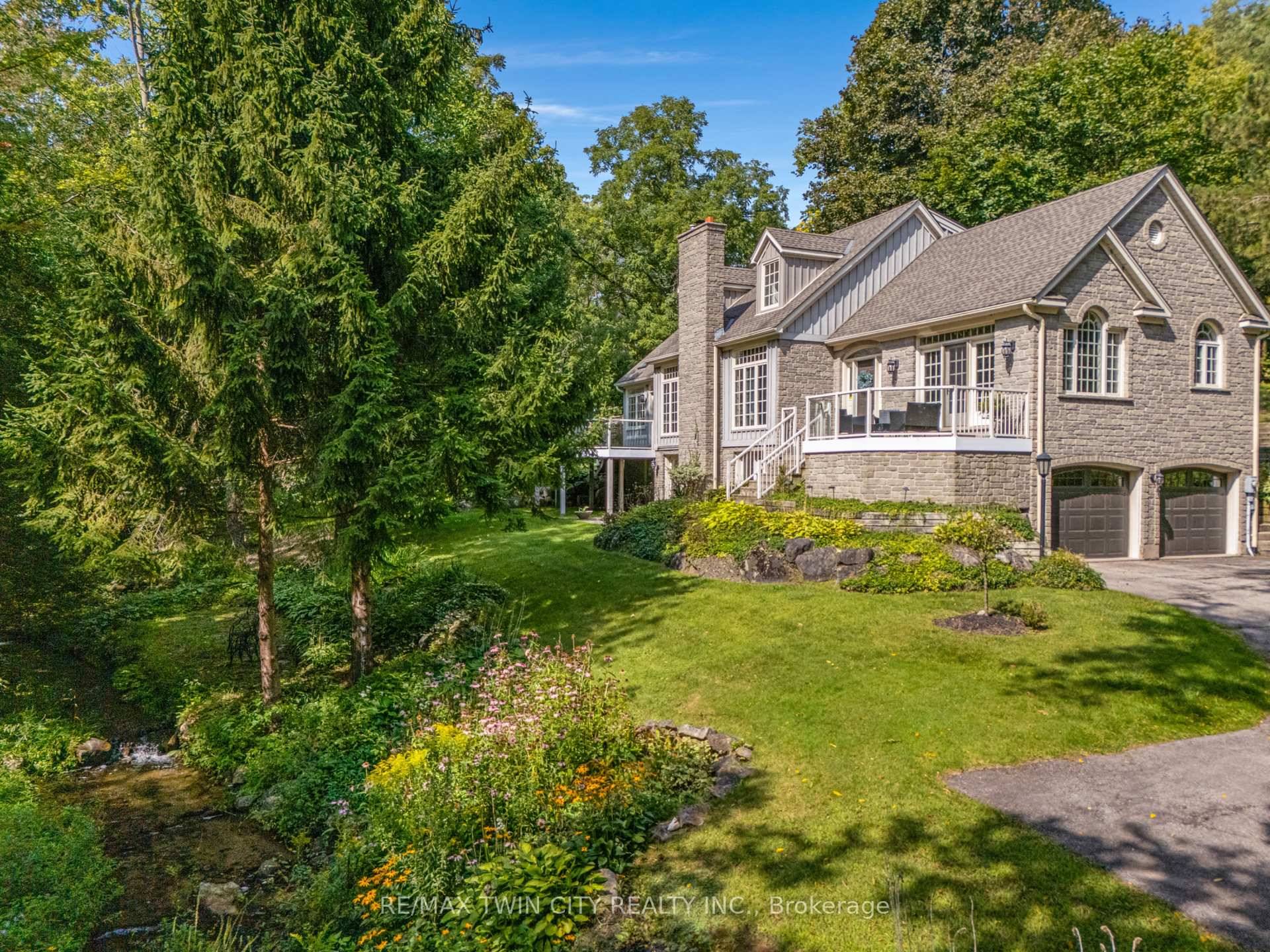 Welcome to 1298 West River Road Tranquility Meets Timeless StyleSurrounded by mature trees and a gentle stream, this bungalow loft blends peaceful country living with city convenience just minutes away.