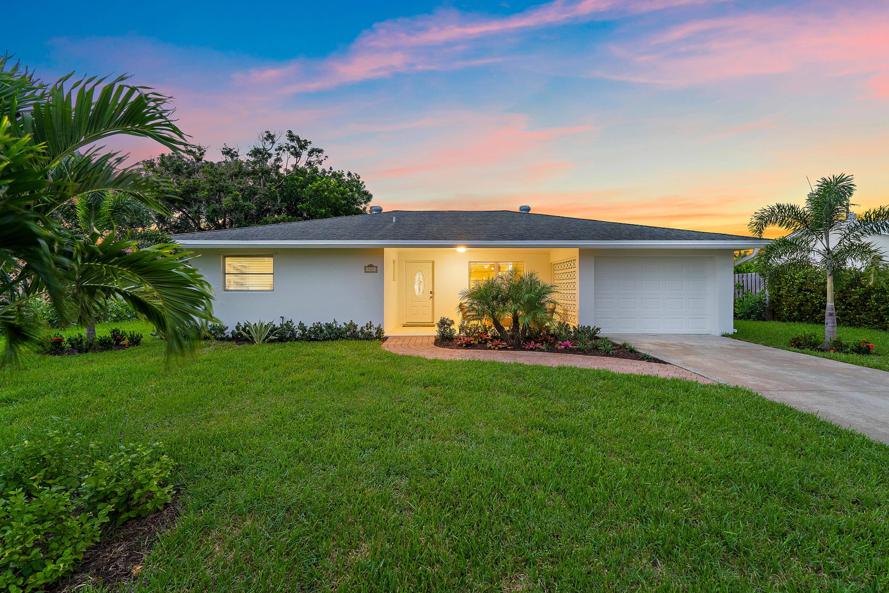 Exquisitely recreated and updated, this single story Tequesta home blends modern comfort with coastal charm.