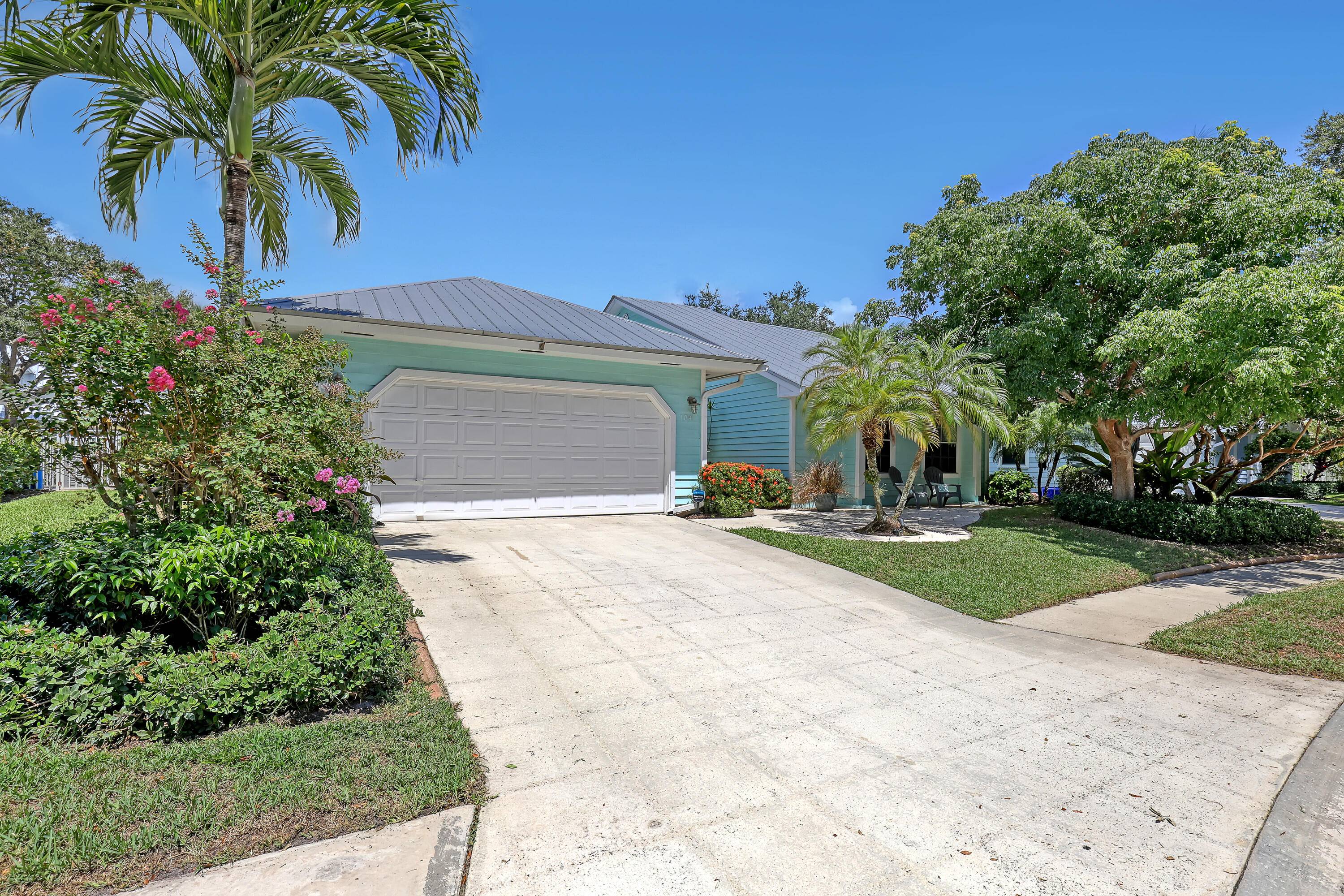 Charming Key West Style Home with Metal Roof This beautifully maintained 3 bedroom, 2 bath gem offers a spacious 2 car garage and numerous upgrades.