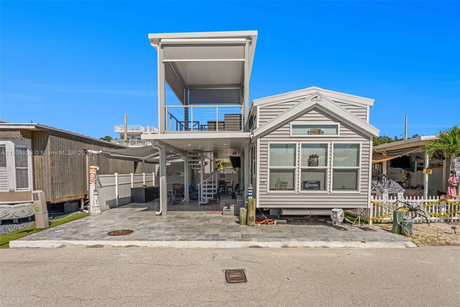 SEE VIRTUAL TOUR LINK ABOVE FOR FULL UNBRANDED VIDEO TO SHARE WITH CLIENTS Open Ocean Calusa Campground Lot 318 with anchored residence, dock, storage and golf cart furnished and turnkey ...