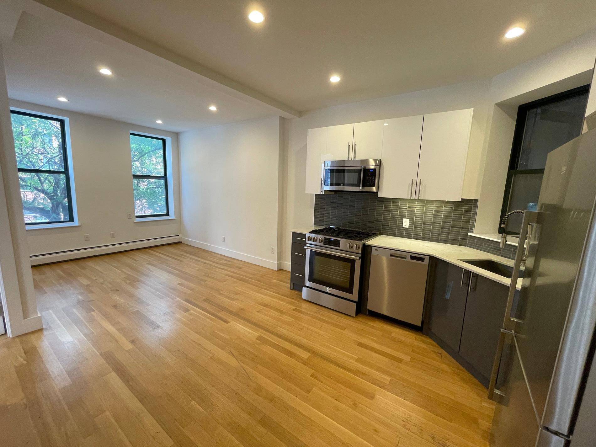 SUNNY AND RENOVATED THREE BEDROOM WITH LAUNDRY IN UNIT !