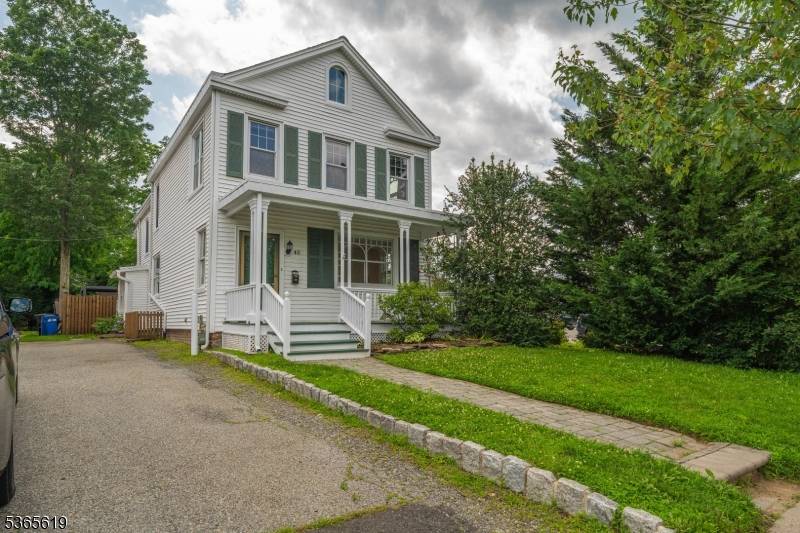 Full of natural light and charm, this home features wide plank hardwood floors, a cozy wood burning fireplace, and a bright, updated kitchen with stainless steel appliances and a large ...