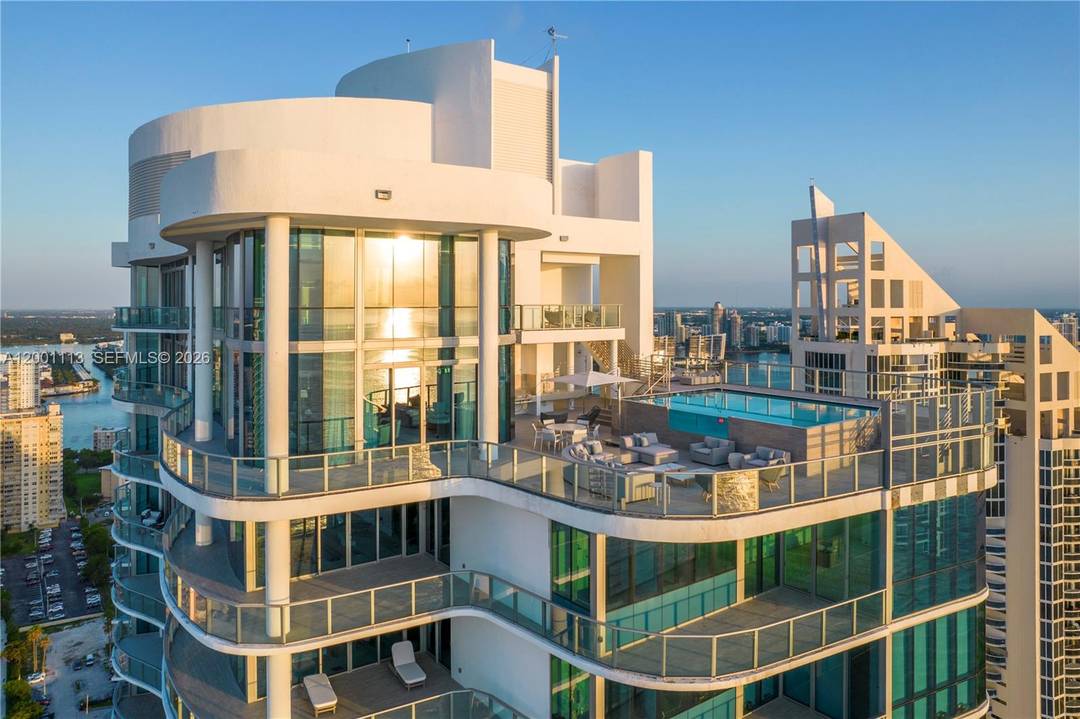 A trophy duplex penthouse defined by sweeping horizons, grand scale, and total privacy above the coastline.