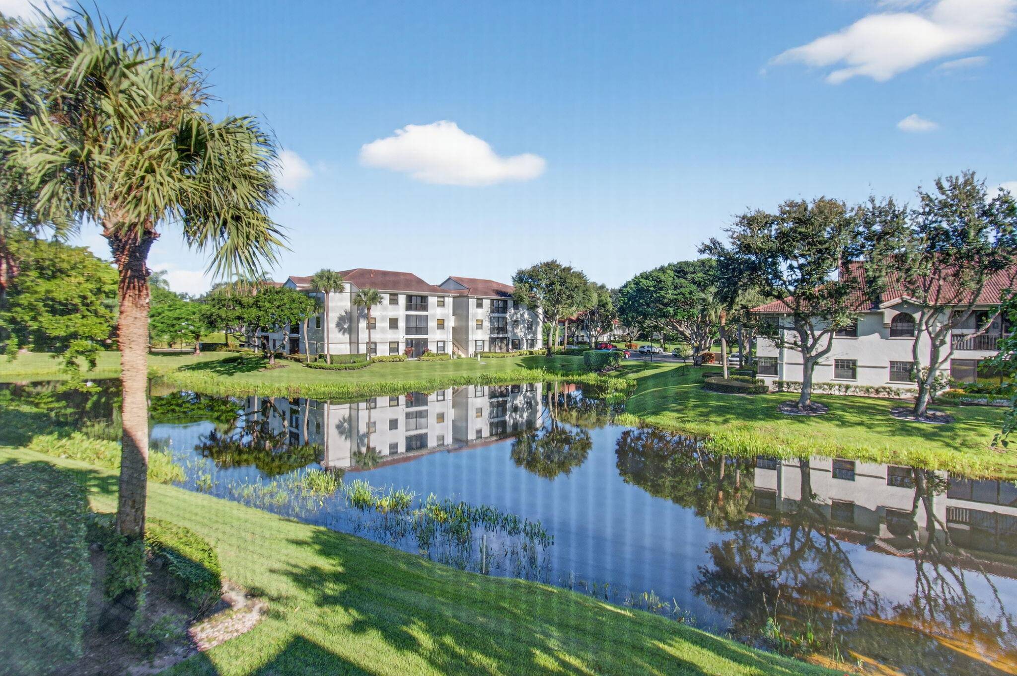 Exquisite three bedroom, two bath condo in Platina's Illustre Village offers a picturesque lake view from every window.