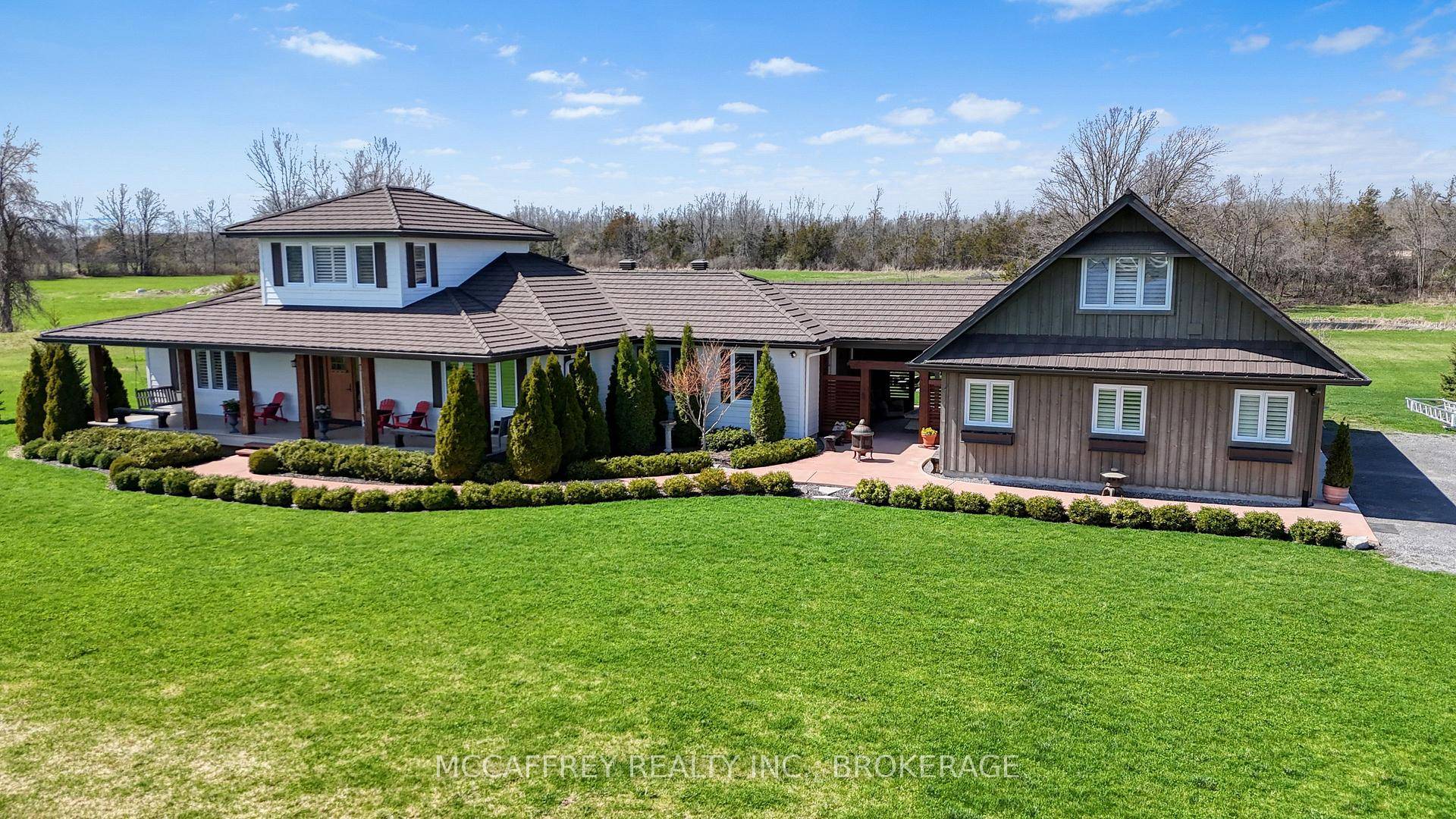 This custom built bungaloft, nestled on impeccably landscaped grounds, is a dream home with sweeping views of Hay Bay and direct water access.