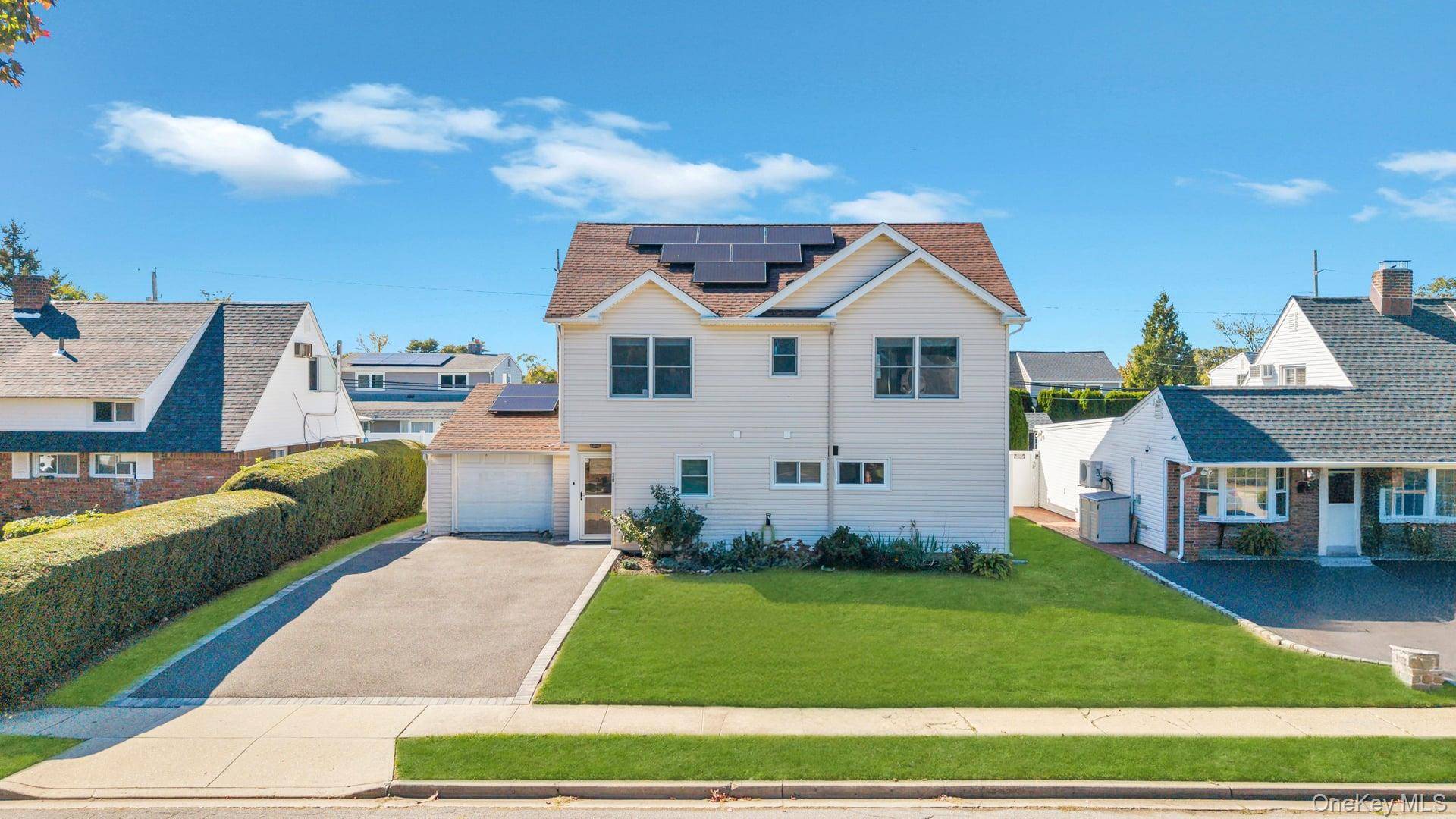 Welcome to this stunning colonial in Hicksville, which perfectly blends modern comfort with classic charm !