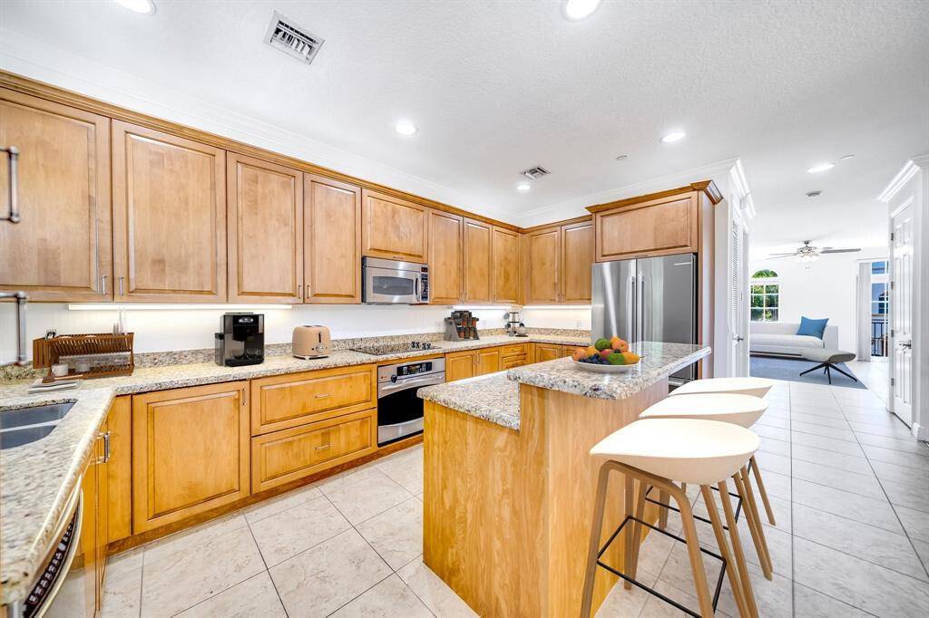 Inside the exclusive, gated, waterfront community of Estancia is this spacious, southern facing, 3 story end unit townhome on the Intracoastal Canal.