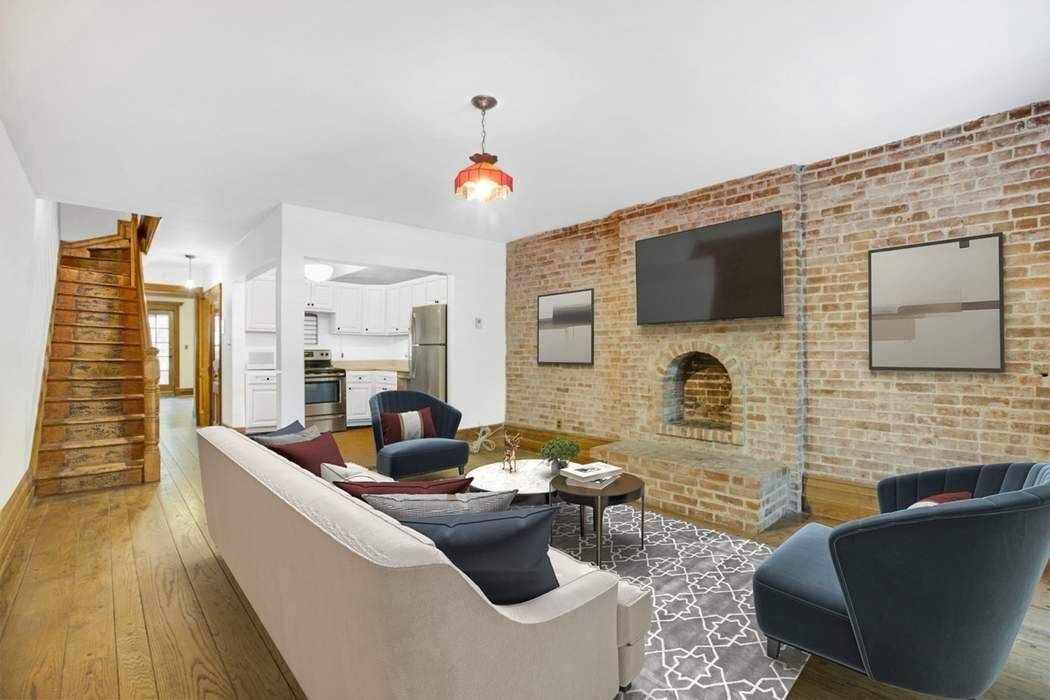 This full floor garden duplex has been lovingly restored and maintains the originality and scale of the townhome's 15 foot wide Federal design.