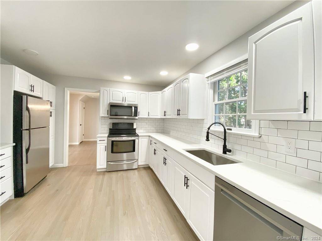 Updated 4 bedroom, 1. 5 bath townhouse with quartz counters and stainless steel appliances !