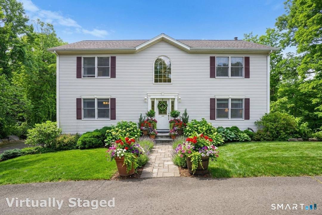 Experience classic New England charm in this beautiful colonial nestled at the bottom of a hill, offering gorgeous lake views from nearly every room.