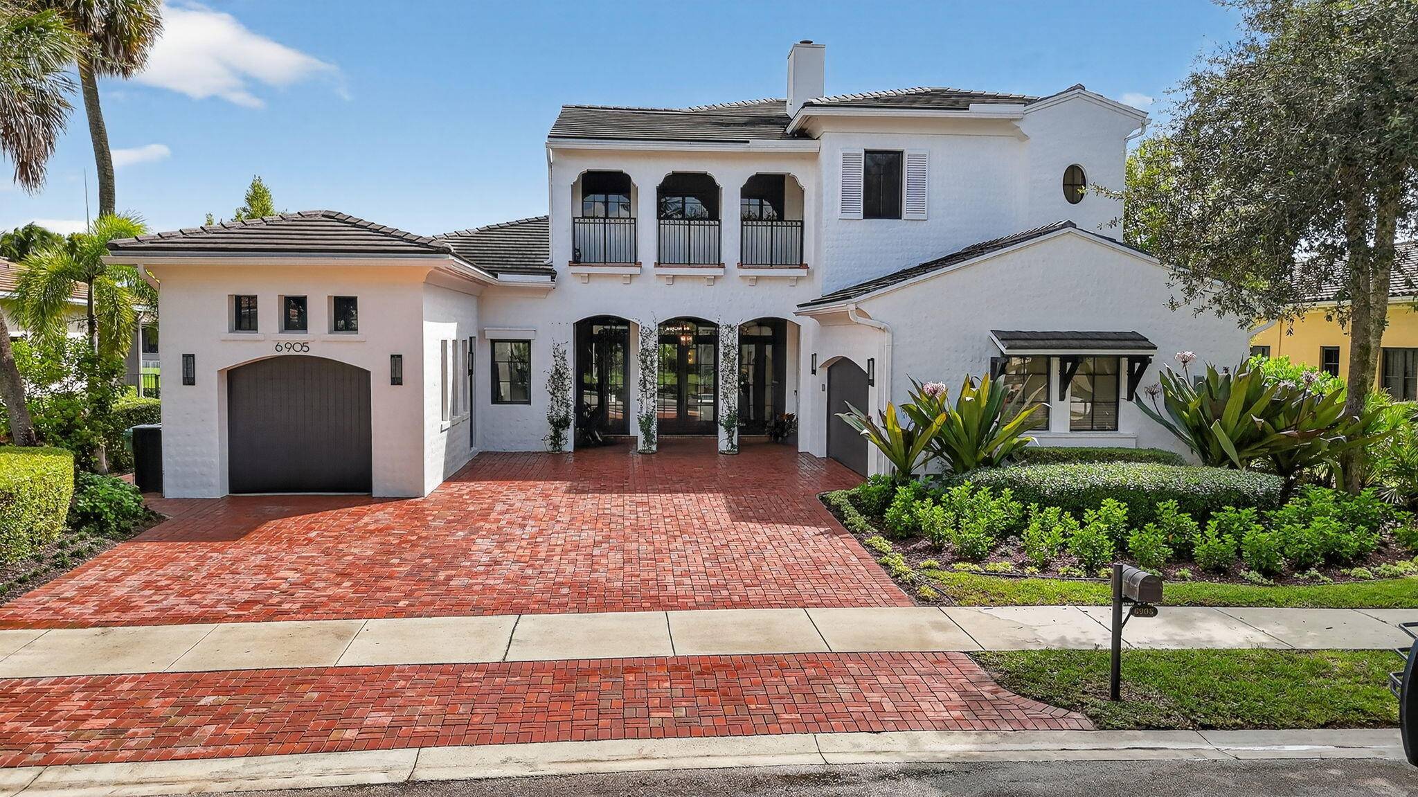 Experience refined luxury in this move in ready waterfront estate on one of Parkland Golf Country Club's most prestigious streets.
