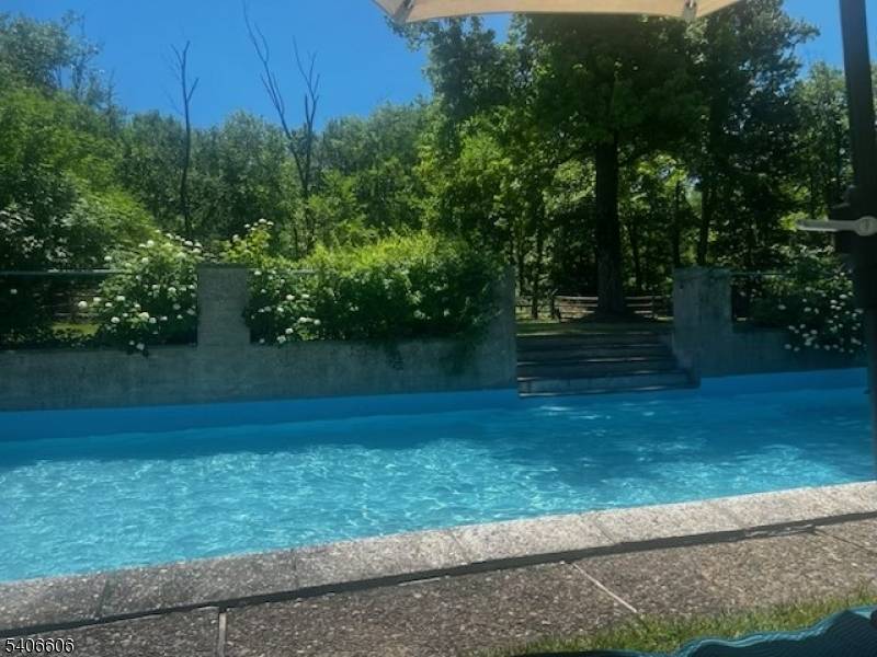 A timeless 1920's manor estate showcasing old world charm seamlessly enhanced with modern conveniences, set on 13 private acres just minutes from downtown Princeton.