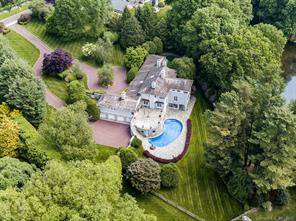 Light filled Contemporary with open floor plan on private near town cul de sac embraces 3.