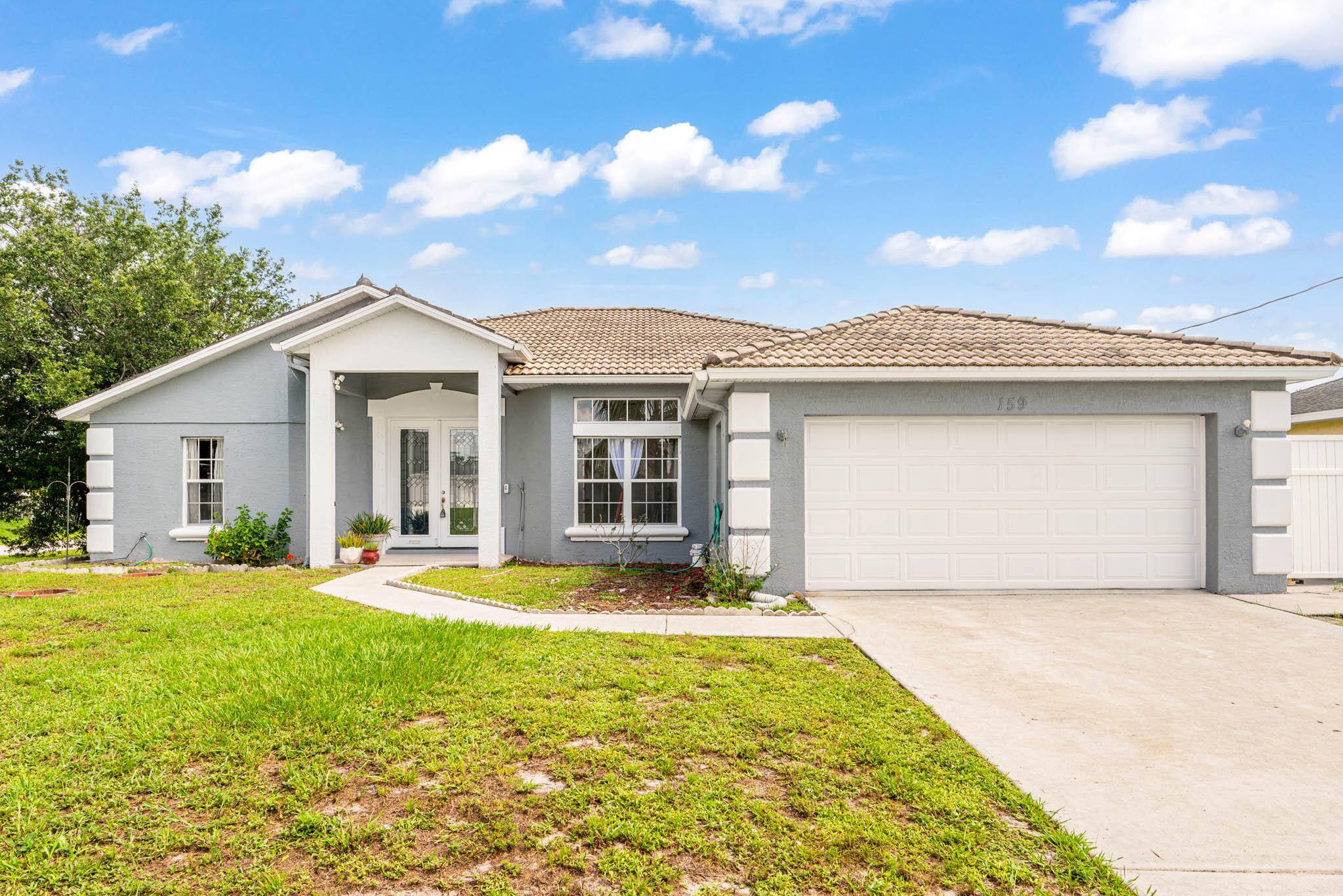 Enjoy multi family living or rental income in this grand corner lot home located near the turnpike and I 95 in Port St Lucie.