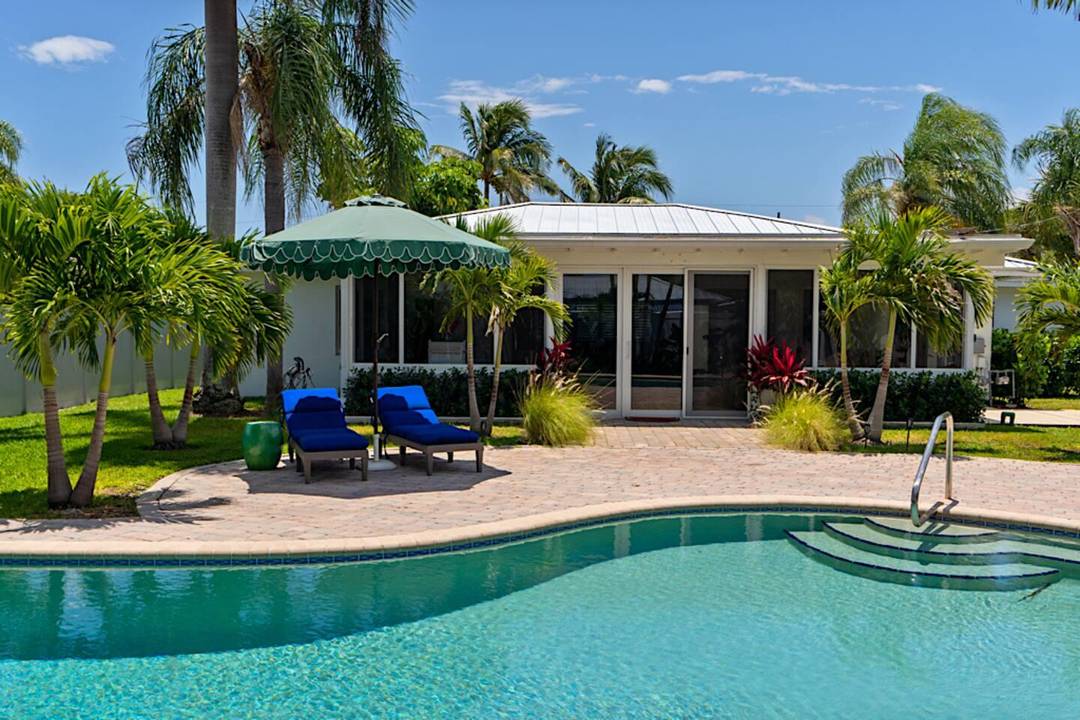 Sunny Bermuda style one story house with open floor plan one block from intracoastal in the heart of the College Park neighborhood in Lake Worth Beach.